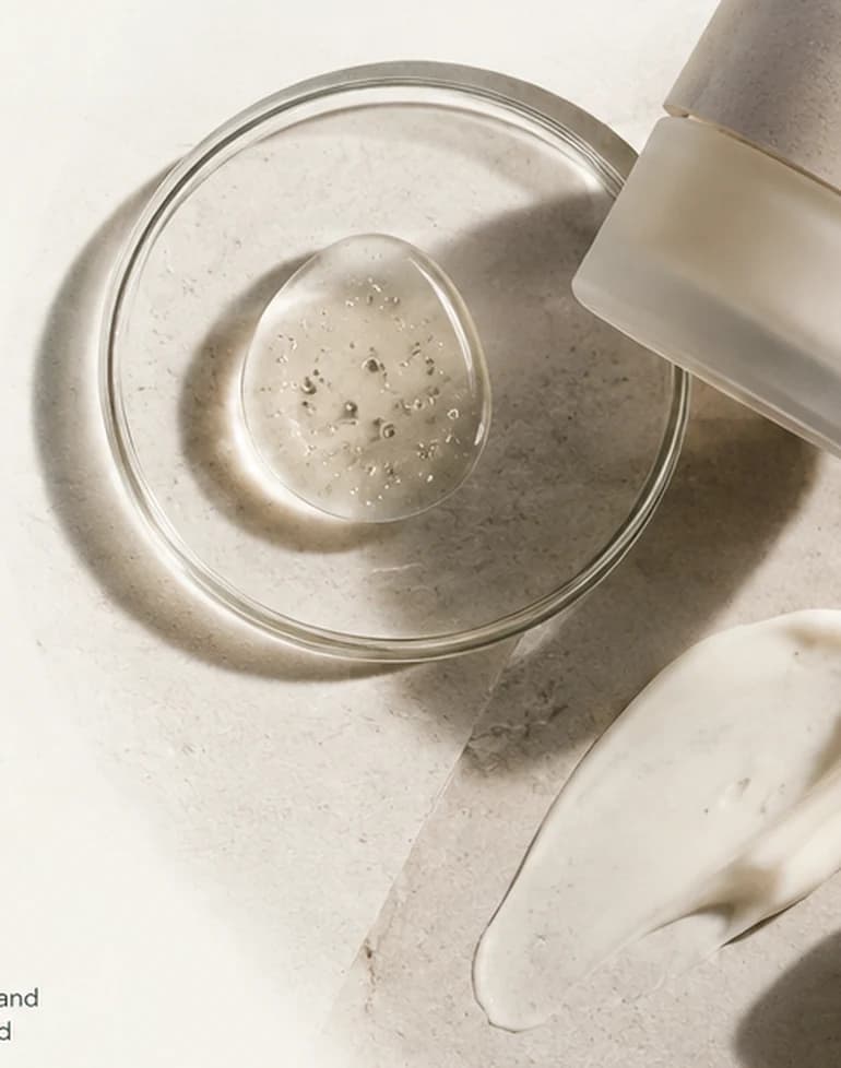 Editorial view of cosmetic textures, formulation glassware and pipette